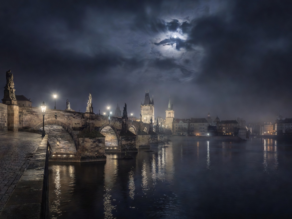 Prague architectural bridge and river under atmospheric night sky
