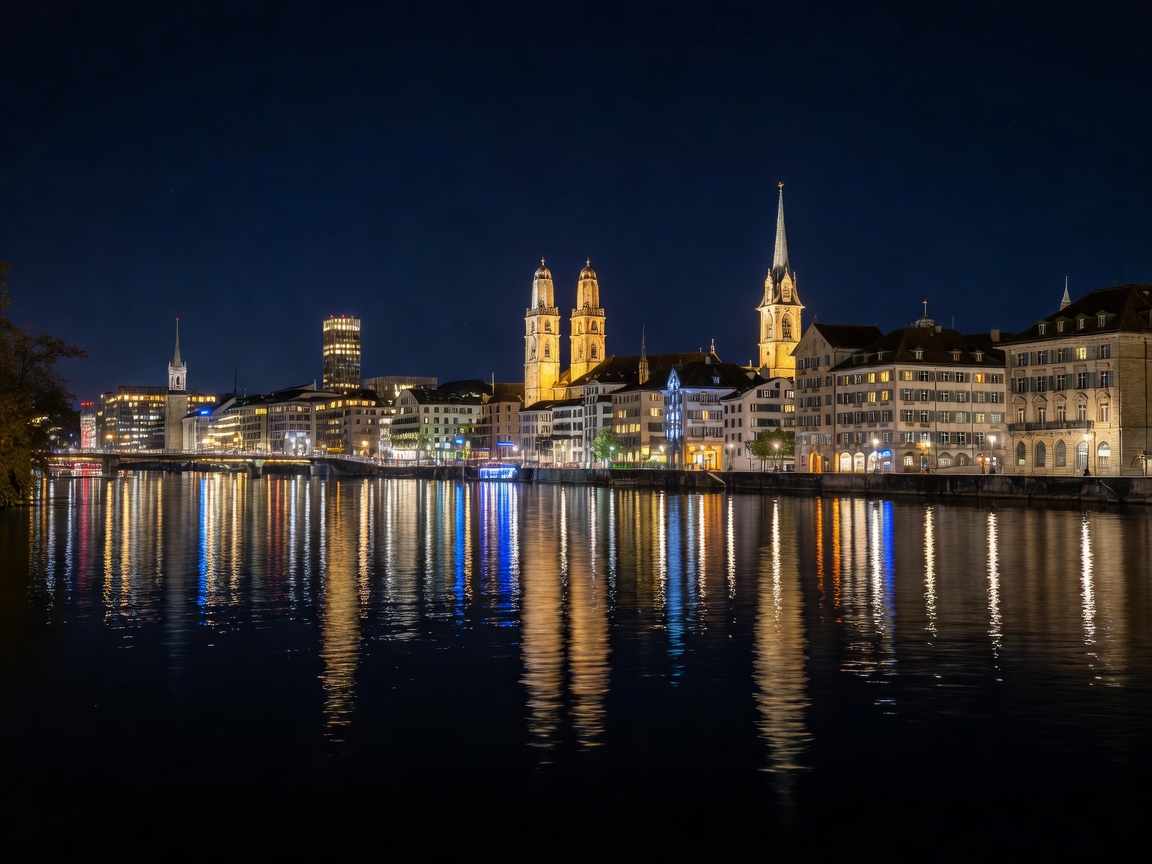 Zurich city skyline at night with reflections over the Limmat river